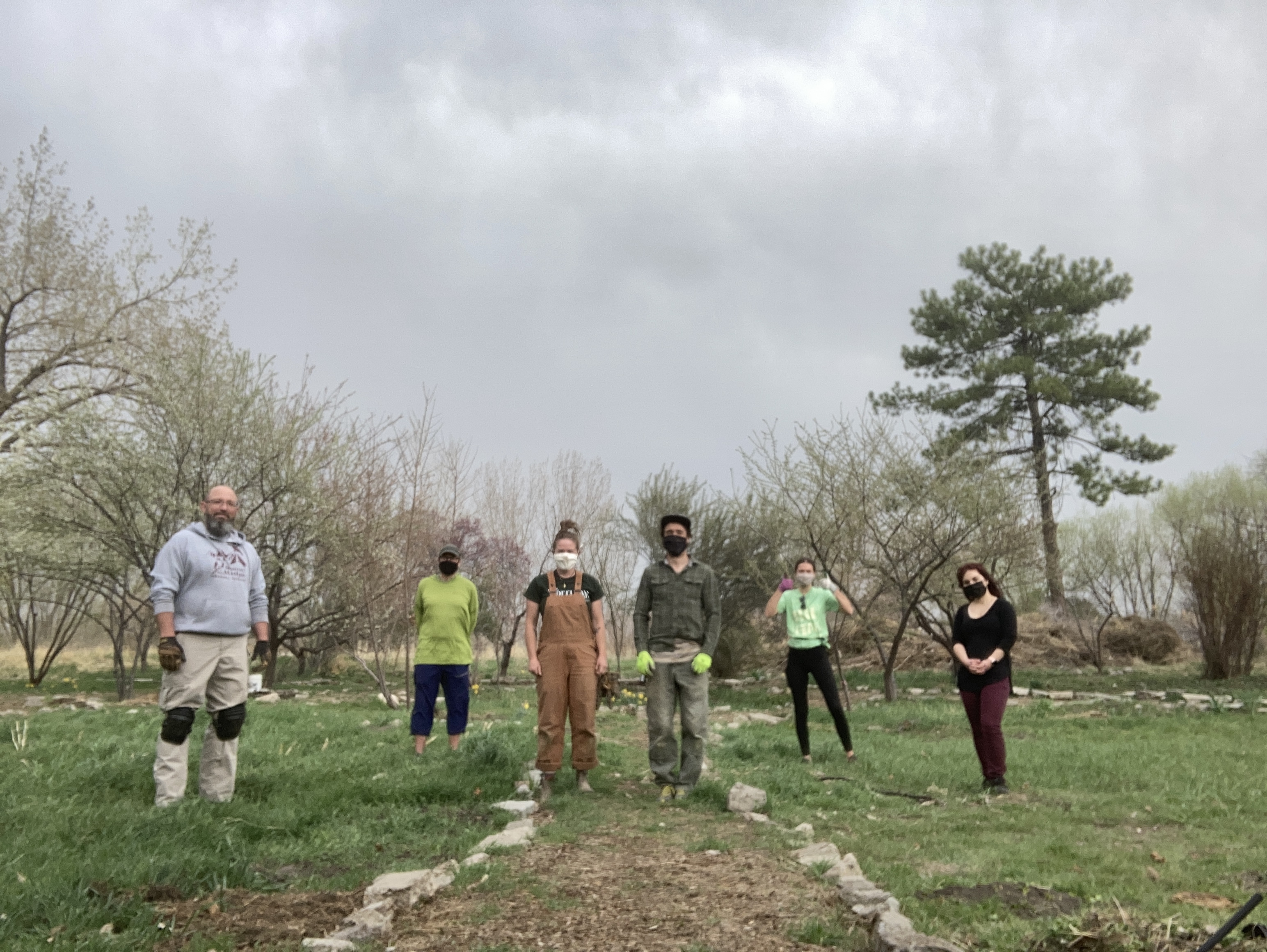 People standing in a row under cloudy sky