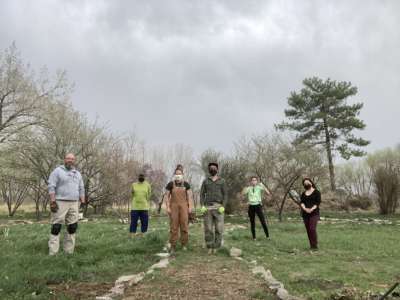 People standing in a row under cloudy sky
