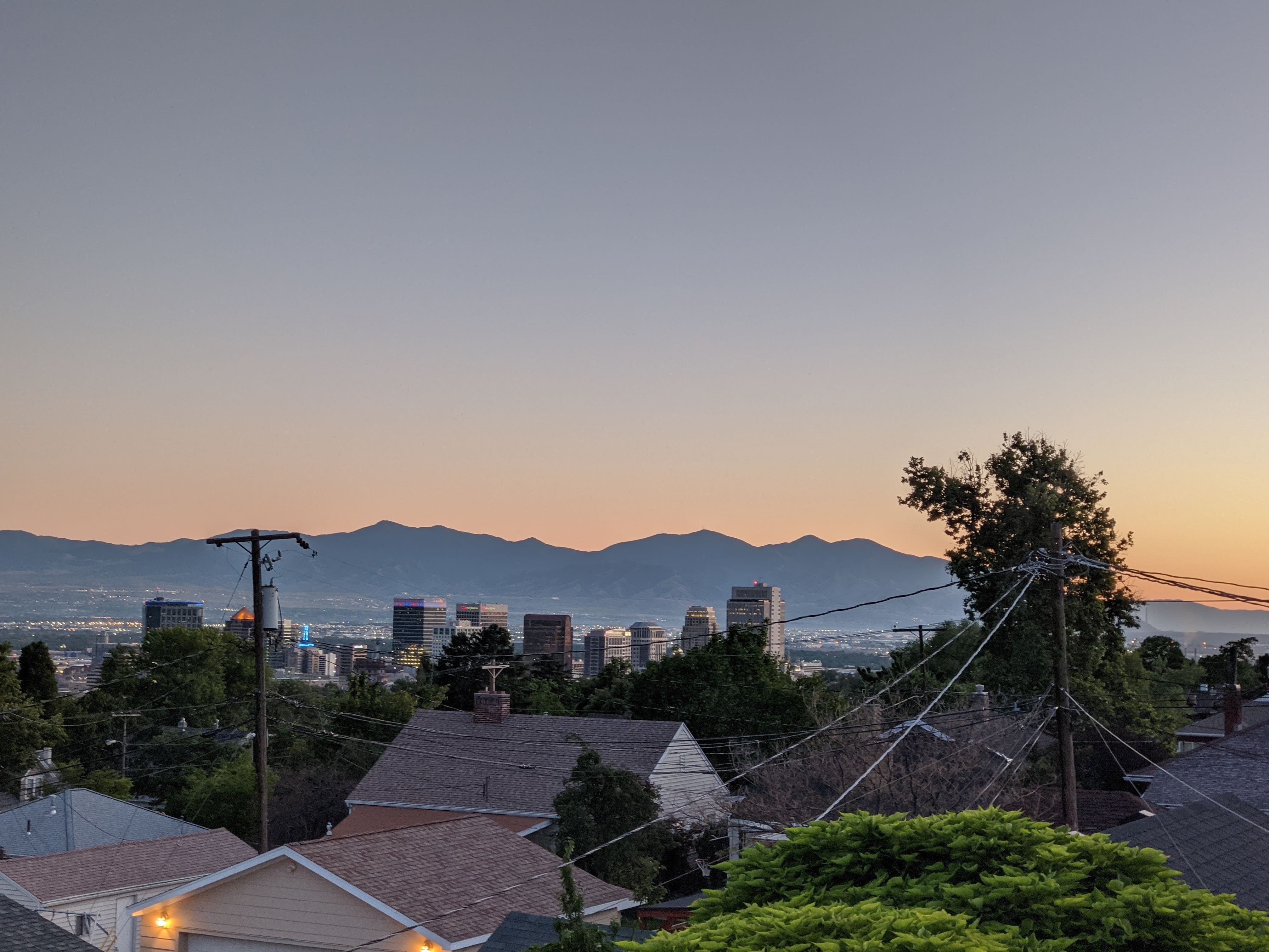 View of house tops with mountains in the distant at dusk