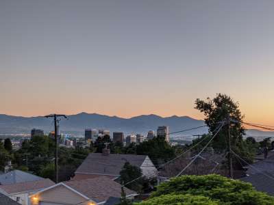 View of house tops with mountains in the distant at dusk
