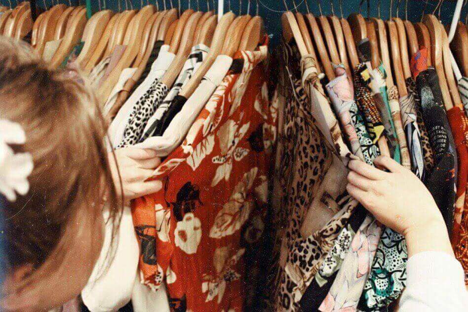 Photo: Woman browsing through clothes (Source: Unsplash)